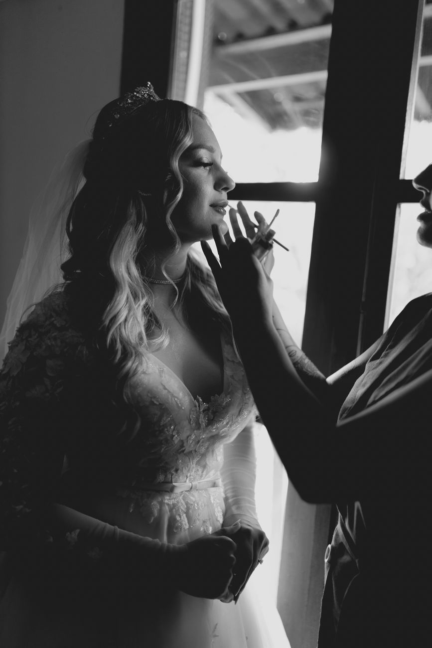 Bride getting ready in window light